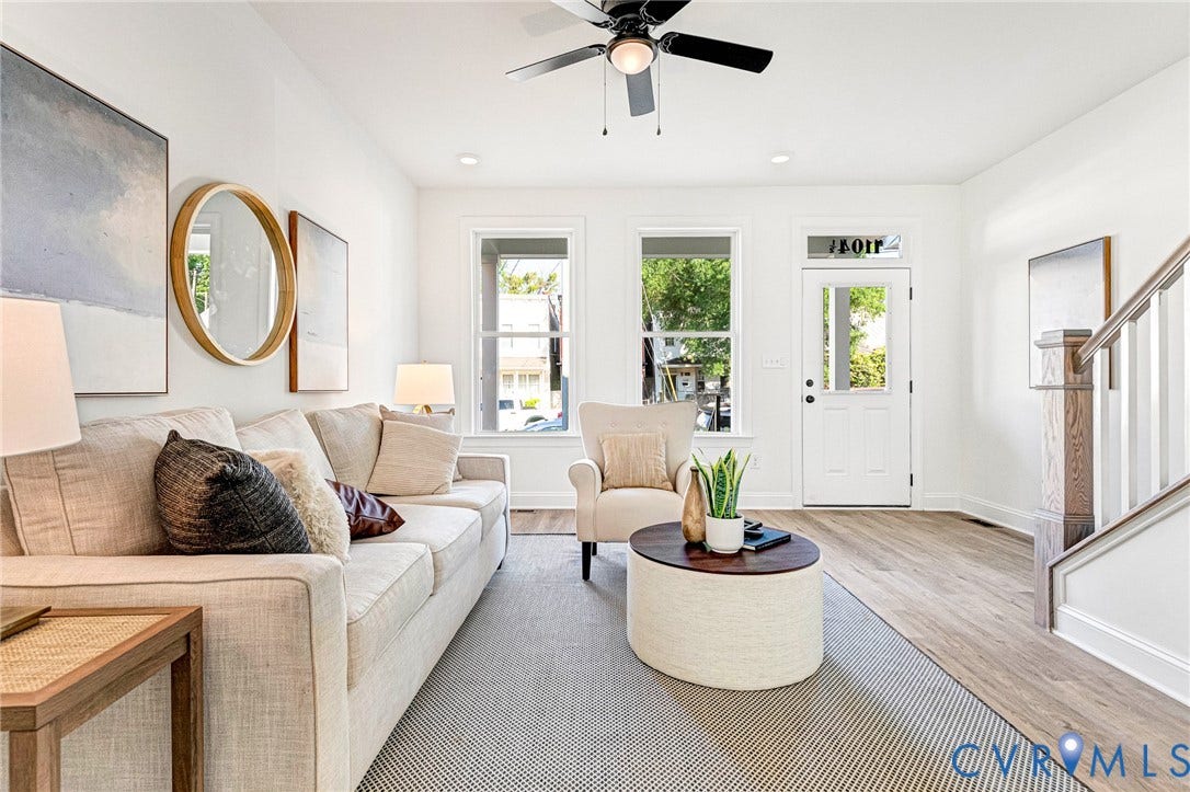Recessed lighting, wood-finish flooring, ceiling fan, white paneled door with transom window, and staircase with wood newel post
