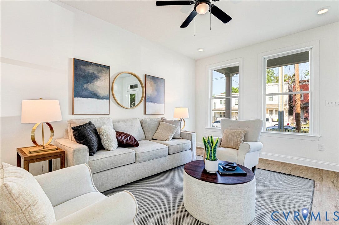 High ceilings, wood-finish flooring, recessed lighting, ceiling fan, and multiple windows