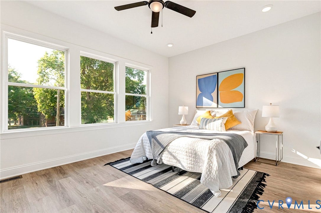 Wood-finish flooring, white walls, and a ceiling fan with integrated lighting
