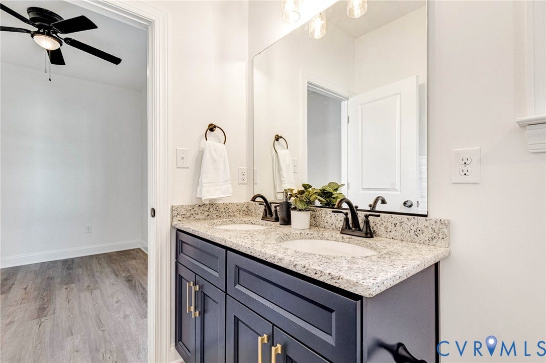 Dual vanity with a speckled countertop and undermount sinks