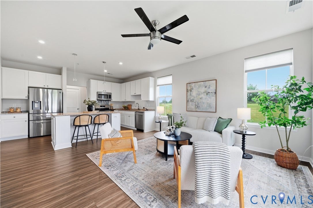 Open living area and kitchen on the first floor with pantry and half bathroom access. Bright, beautiful natural light.