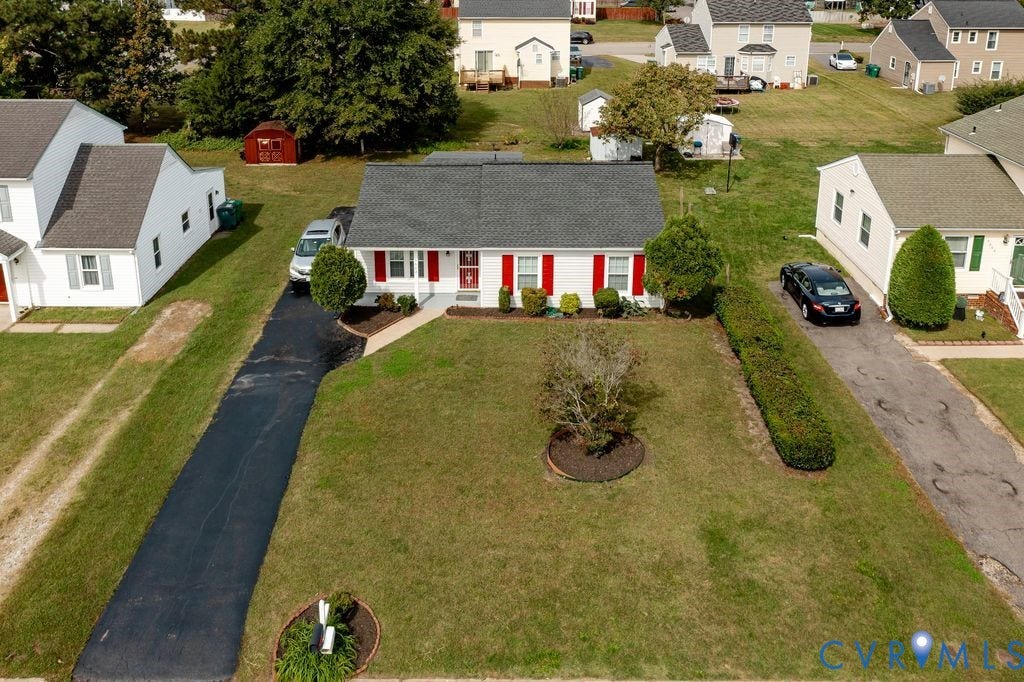 Henrico, VA 23223 Single-story residence featuring a white exterior with contrasting red shutters, asphalt shingle roof, expansive front lawn, and a private asphalt driveway
