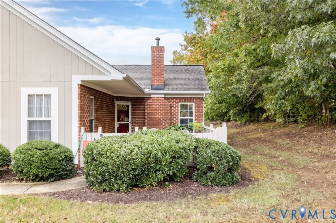 Brick and siding exterior with a patio and fence