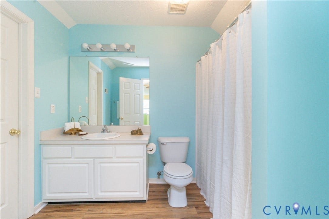 Bathroom featuring a white vanity with integrated sink