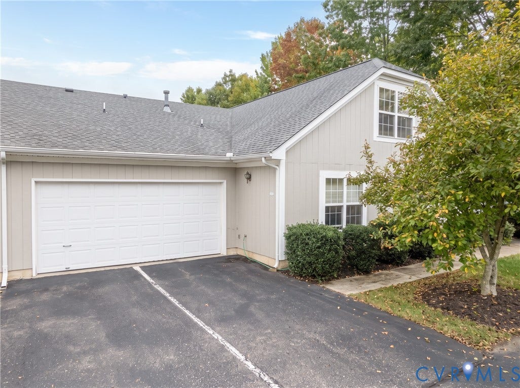 Attached garage with asphalt driveway