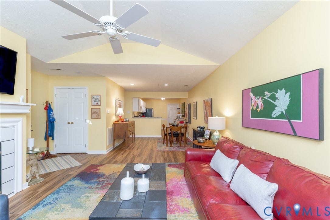 Vaulted ceiling with a ceiling fan, fireplace