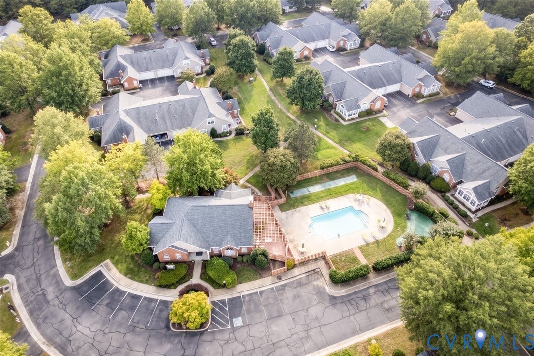 Community amenity building with an outdoor swimming pool and surrounding green space