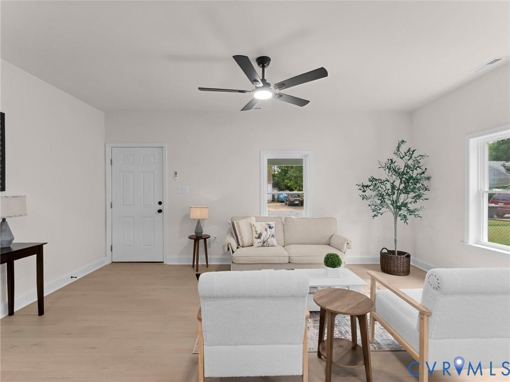 Light wood-finish flooring with white baseboards