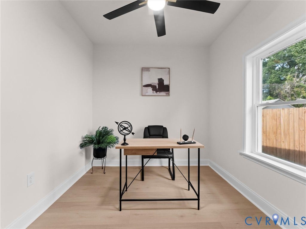 Light-toned wood-finish flooring, white walls, and a ceiling fan with integrated lighting