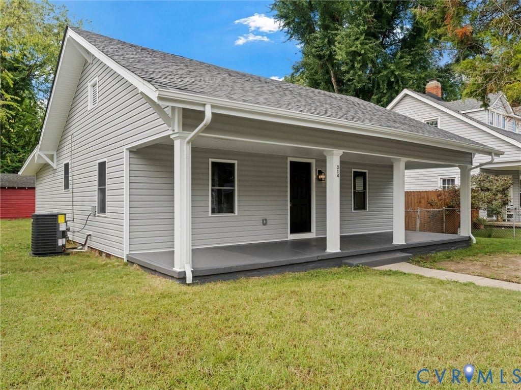 Exterior with gray siding, covered front porch, white columns, and dark-framed windows