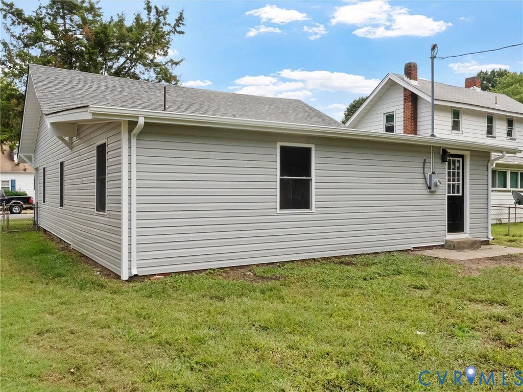 Light gray siding exterior with a dark gray asphalt shingle roof