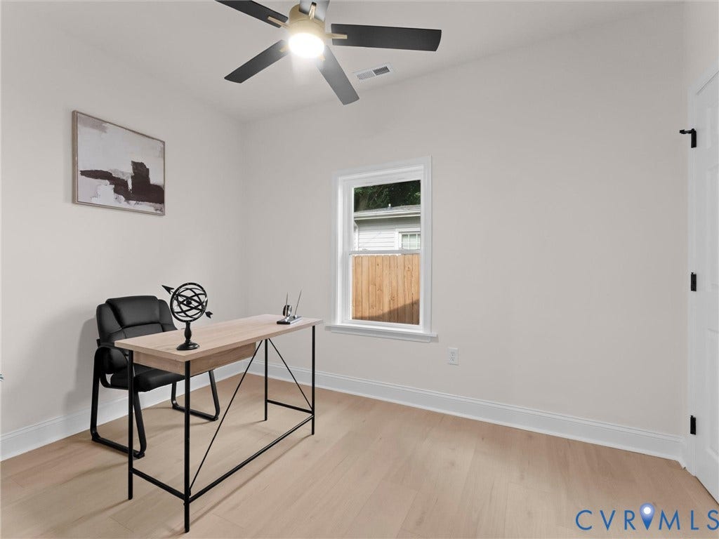 Hardwood-finish flooring with white baseboards, a ceiling fan with integrated lighting, and a single window with white trim