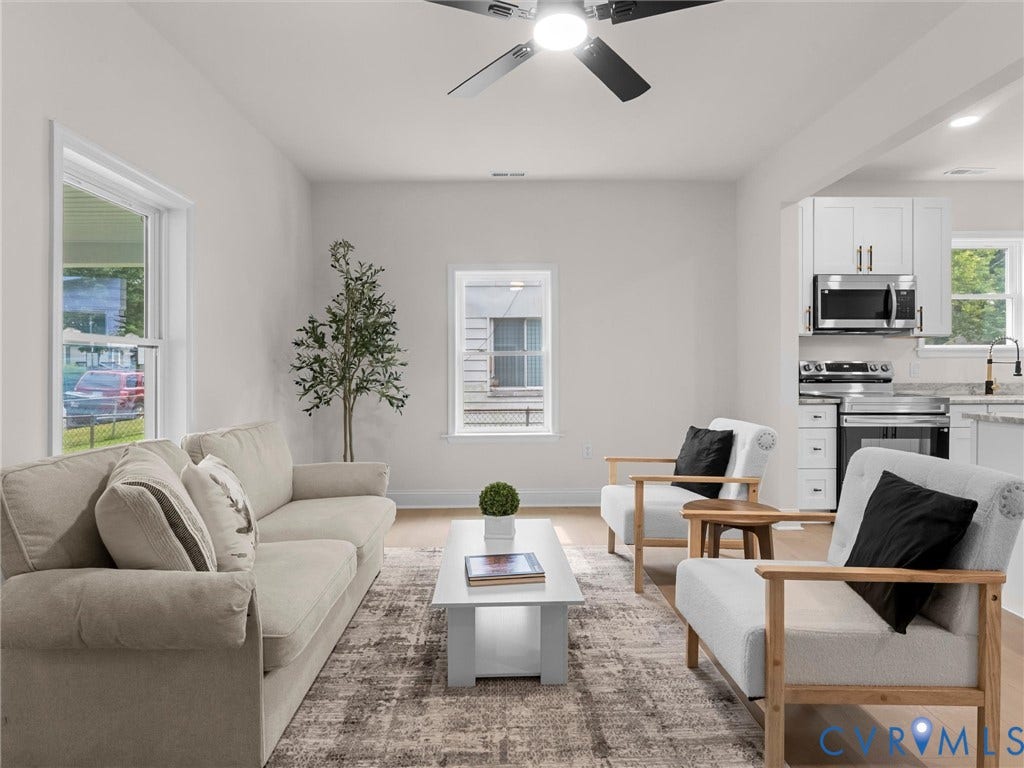 Open concept living area featuring light wood-finish flooring, recessed lighting, and a ceiling fan