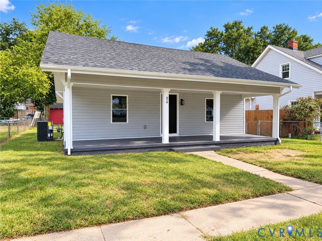 Single-story residence featuring gray siding and a covered front porch with white columns