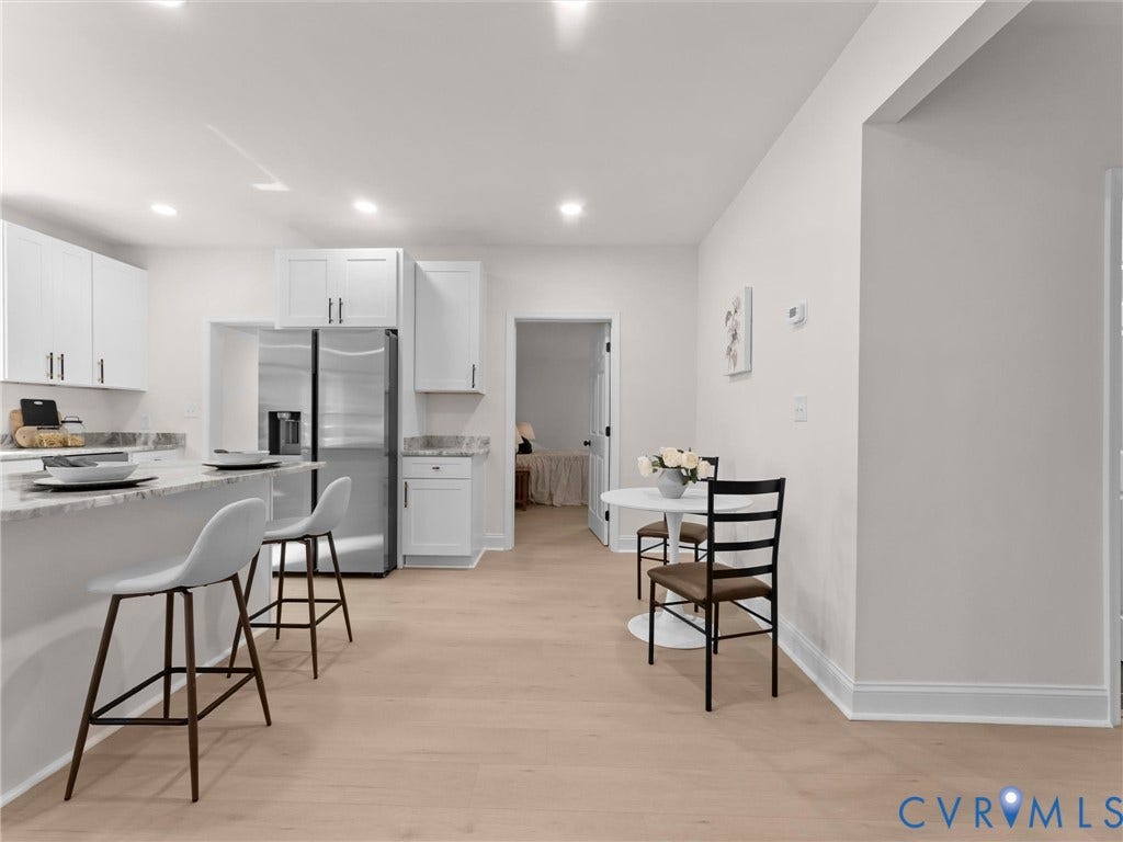 Kitchen featuring white cabinetry, stainless steel refrigerator, light-toned wood-finish flooring, and recessed lighting