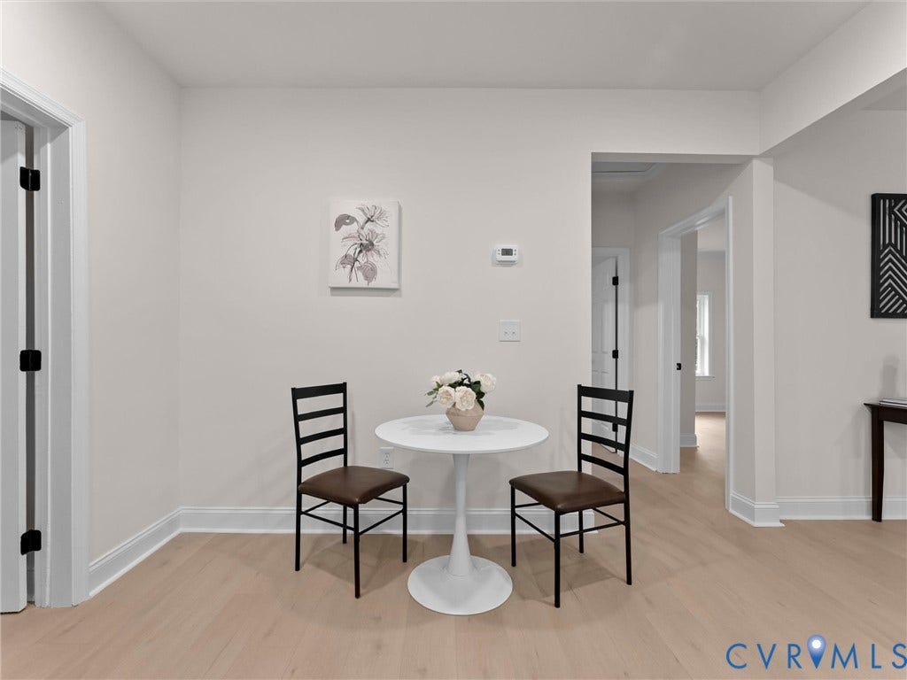 Light wood-finish flooring, white walls, and white trim