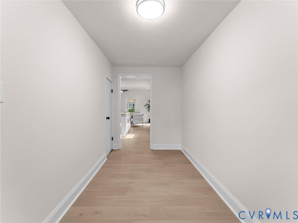 Recessed lighting, light wood-finish flooring, white wall paint, and white trim