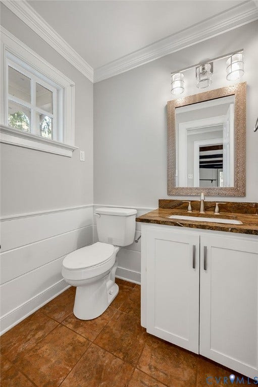10303 Silverbrook Drive, Henrico, VA 23233 White vanity with a brown countertop and integrated sink, complemented by a large framed mirror and three-light fixture