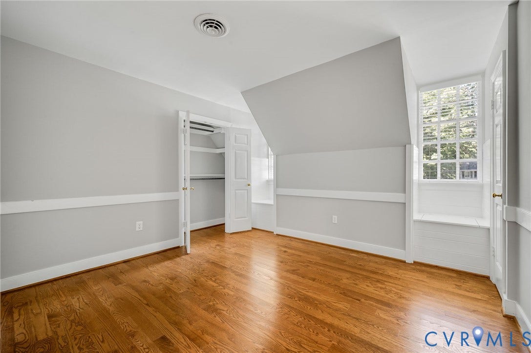 10303 Silverbrook Drive, Henrico, VA 23233 Hardwood flooring, window with built-in bench, bi-fold closet, baseboard trim, and chair rail molding