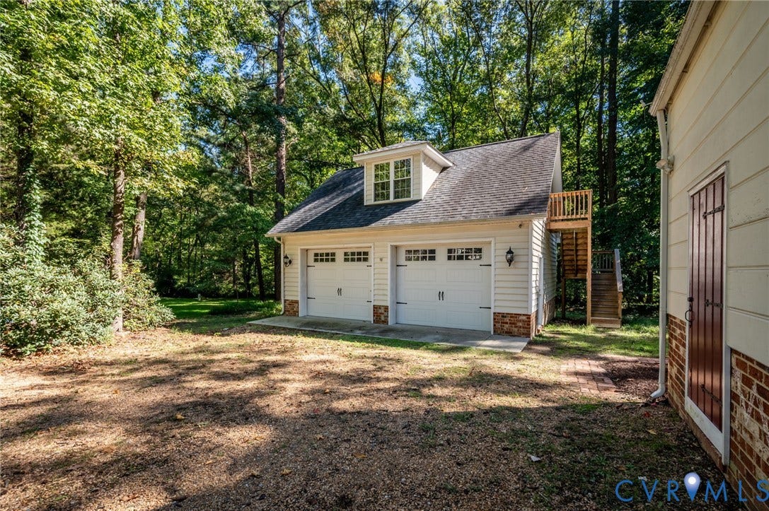 10303 Silverbrook Drive, Henrico, VA 23233 Two-car garage with overhead doors featuring window inserts