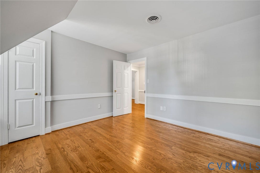 10303 Silverbrook Drive, Henrico, VA 23233 Wood-finish flooring, white paneled doors, and light gray walls with chair rail molding