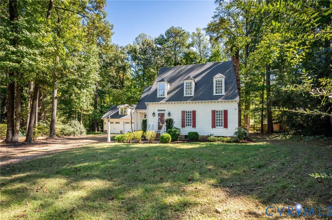 10303 Silverbrook Drive, Henrico, VA 23233 White clapboard siding with red shutters, a dormer roofline, and a two-car garage