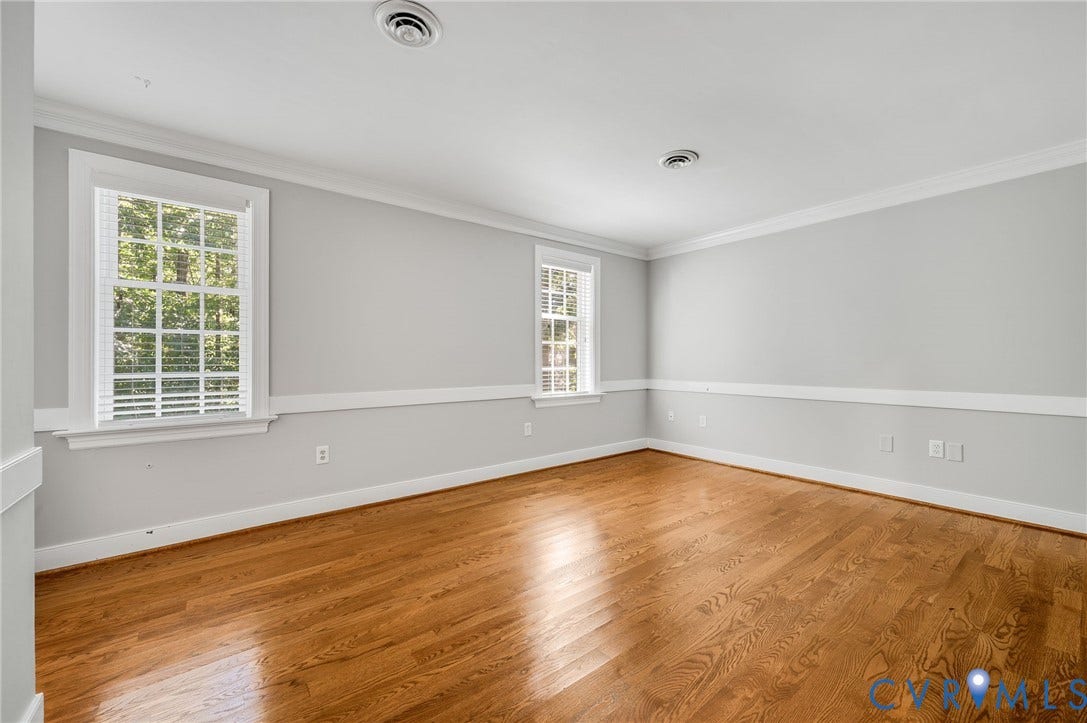 10303 Silverbrook Drive, Henrico, VA 23233 Hardwood flooring throughout, crown molding, chair rail, and multiple windows with blinds