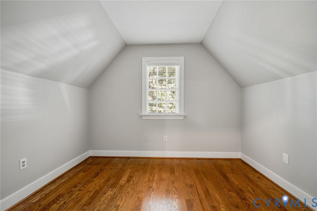 10303 Silverbrook Drive, Henrico, VA 23233 Hardwood flooring, crisp white trim, and a double-hung window are featured in this room with sloped ceilings