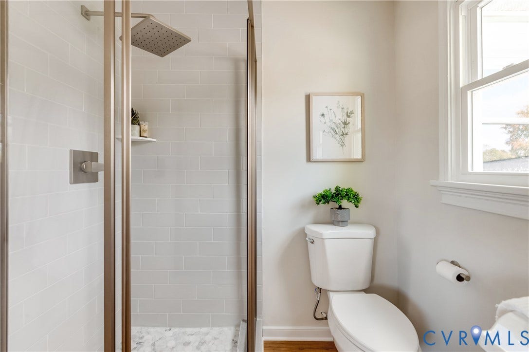 8010 Callison Drive, Glen Allen, VA 23060 Shower enclosure with subway tile surround, rain shower head, and a built-in shelf