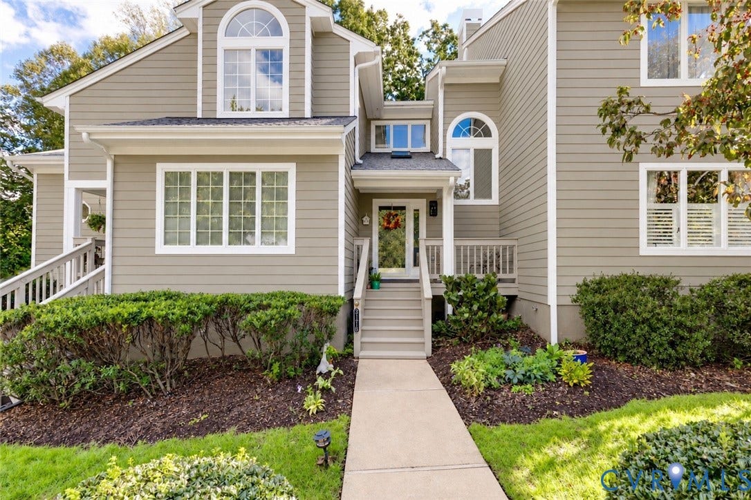 3131 Stony Point Road, #B, Richmond, VA 23235 Multi-level exterior with dormer window, light tan siding, white trim, and a concrete pathway