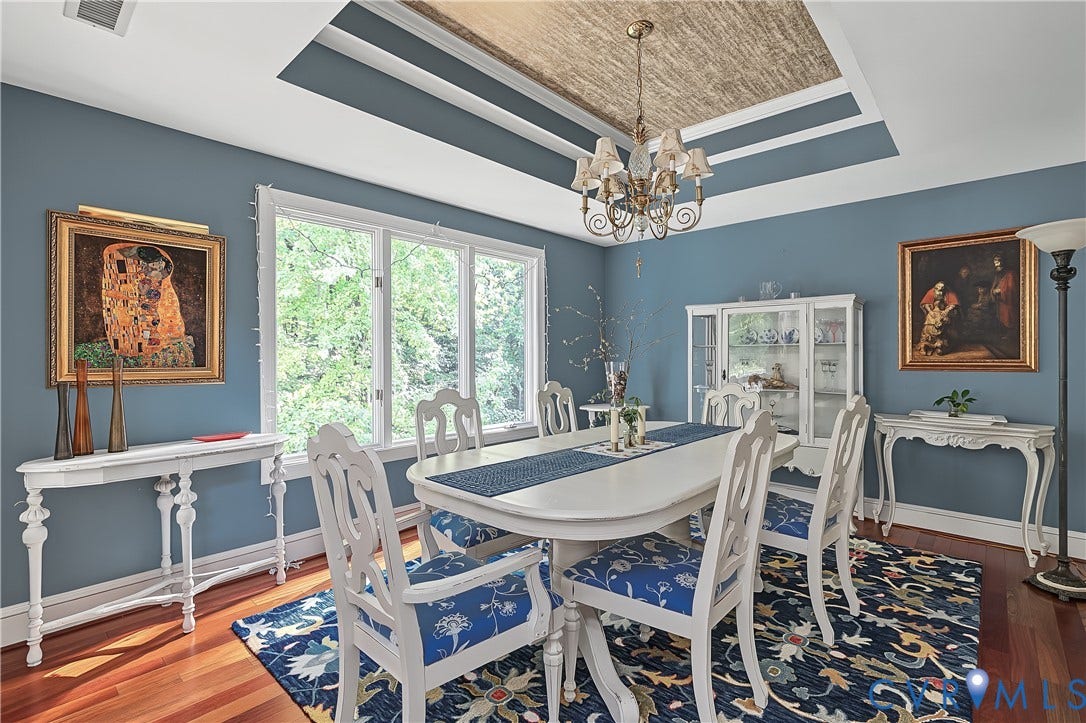 3131 Stony Point Road, #B, Richmond, VA 23235 Tray ceiling with textured inset, prominent window providing natural light, hardwood flooring, and a decorative chandelier
