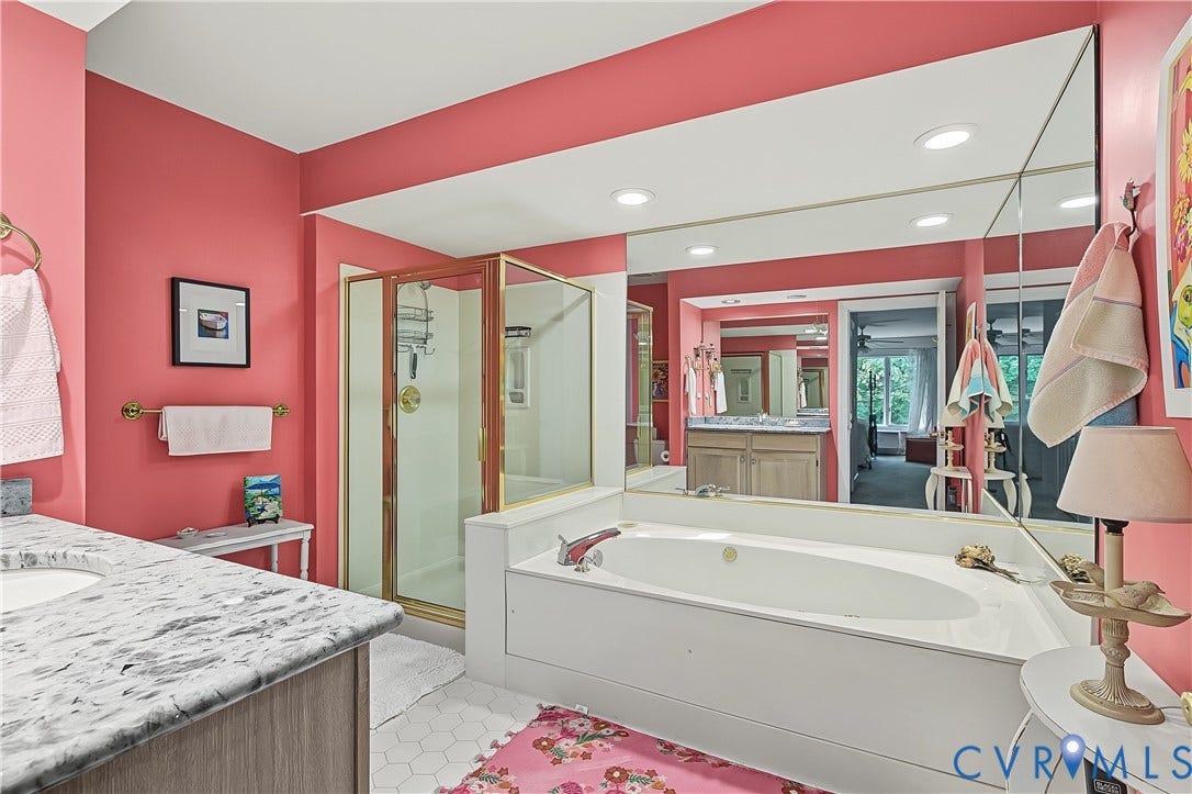 3131 Stony Point Road, #B, Richmond, VA 23235 Dual vanity with stone-finish countertop, built-in soaking tub, separate glass-enclosed shower, and hexagonal floor tiling