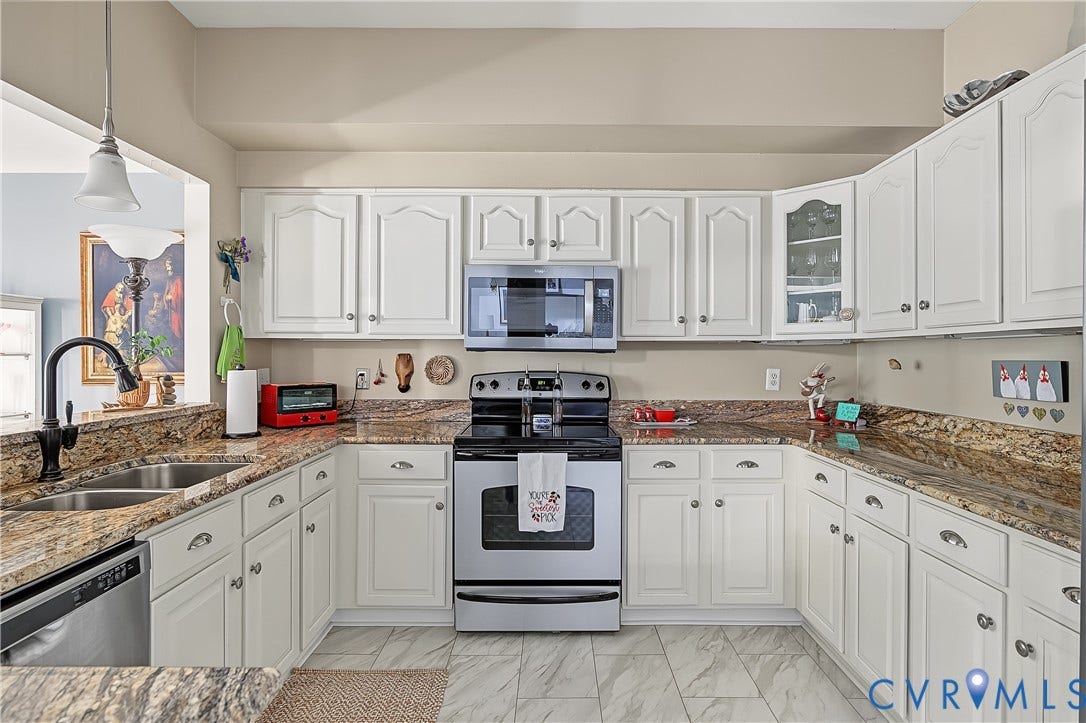 3131 Stony Point Road, #B, Richmond, VA 23235 U-shaped kitchen featuring white cabinetry, stone countertops, stainless steel appliances, and tile flooring