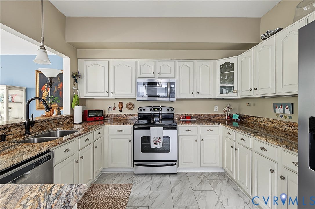3131 Stony Point Road, #B, Richmond, VA 23235 U-shaped kitchen with white cabinetry, granite-style countertops, stainless steel appliances, and tile flooring
