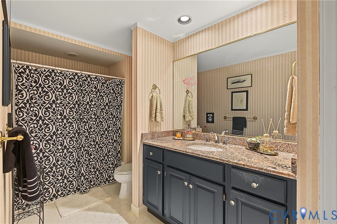 3131 Stony Point Road, #B, Richmond, VA 23235 Vanity with an integrated sink, stone countertop, and custom cabinetry