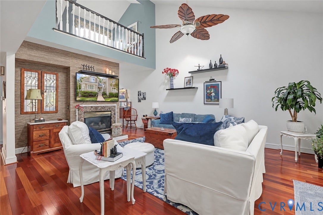 3131 Stony Point Road, #B, Richmond, VA 23235 Vaulted ceiling with a decorative ceiling fan, wood-finish flooring, and a fireplace with a stone surround