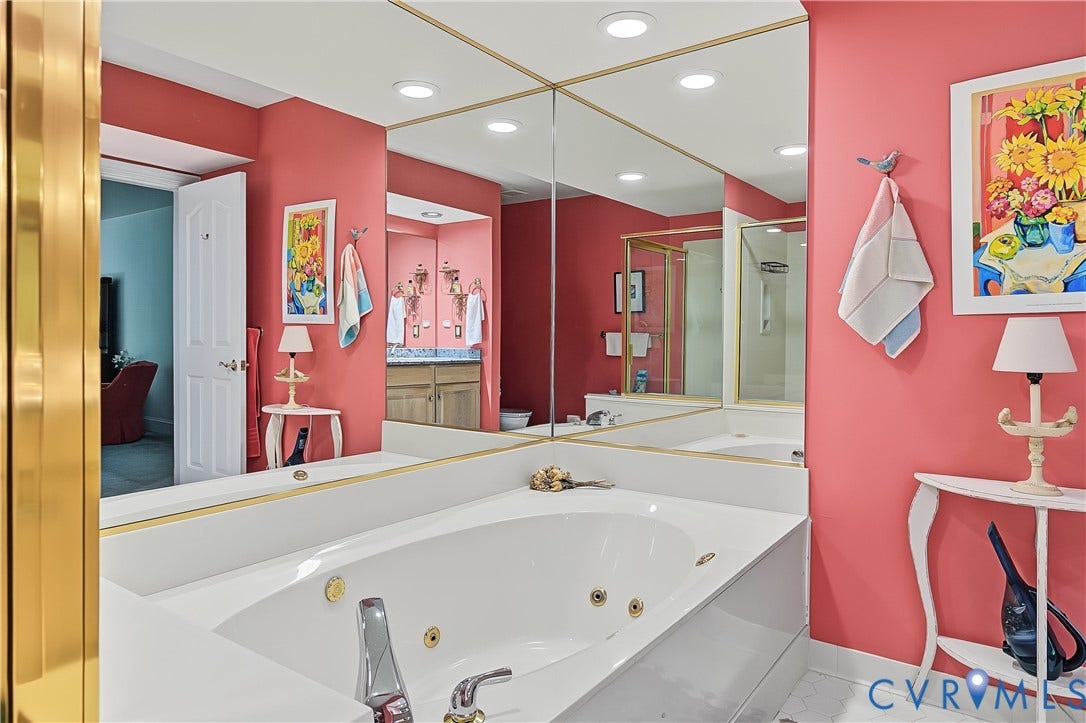 3131 Stony Point Road, #B, Richmond, VA 23235 Jetted soaking tub with chrome fixtures, large wall-mounted mirror, and recessed lighting