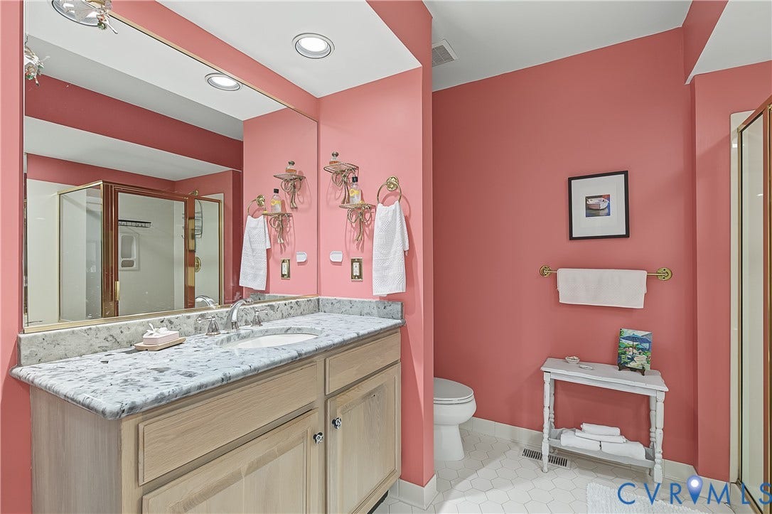 3131 Stony Point Road, #B, Richmond, VA 23235 Dual sink vanity with stone countertop, integrated mirror, and recessed lighting