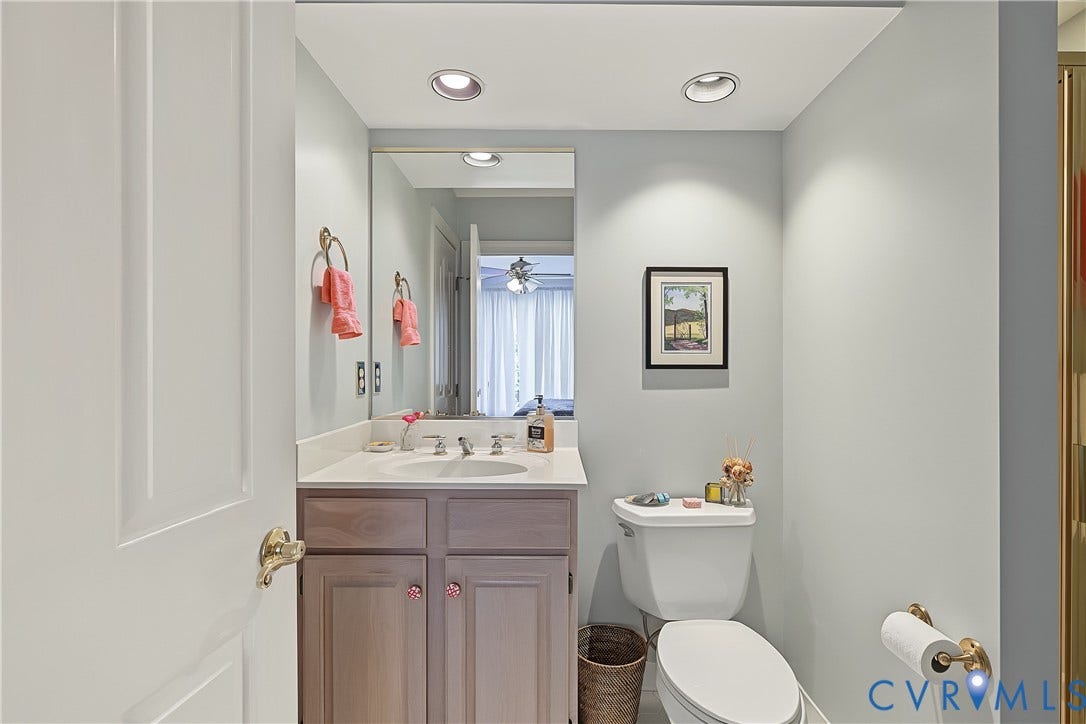 3131 Stony Point Road, #B, Richmond, VA 23235 Recessed lighting, integrated sink, wood-finish vanity with cabinet storage, wall-mounted mirror, and white toilet