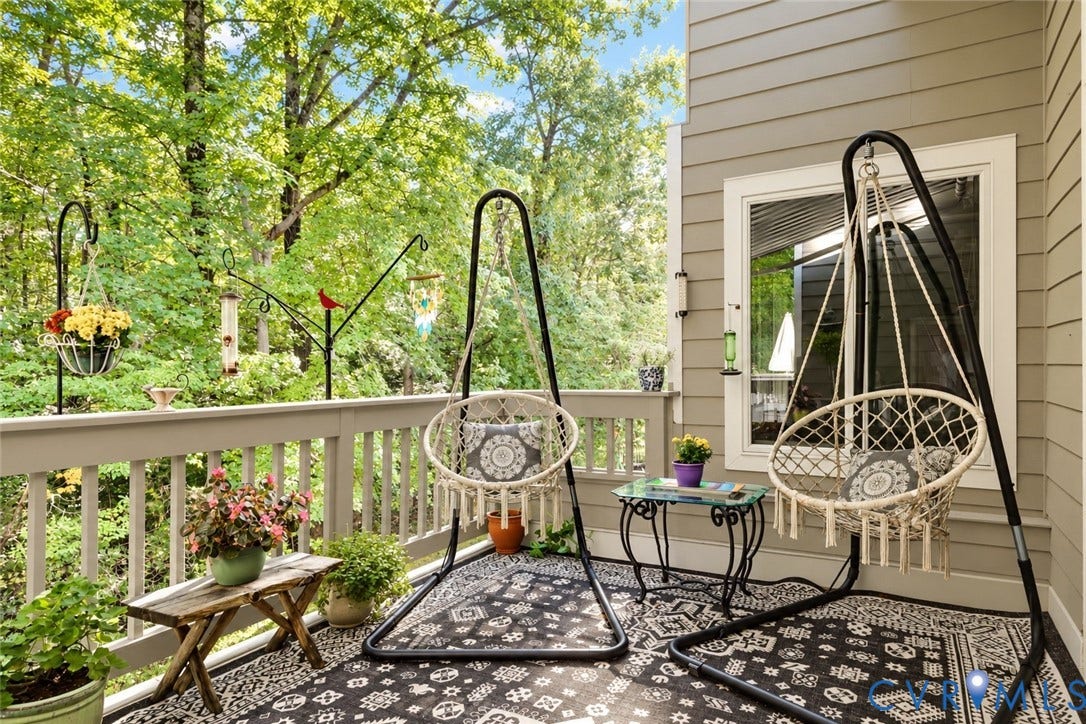 3131 Stony Point Road, #B, Richmond, VA 23235 Exterior deck with wood-finish railing, featuring horizontal siding and a white-framed window