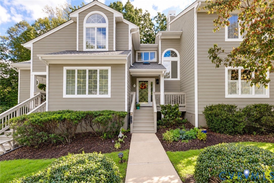 3131 Stony Point Road, #B, Richmond, VA 23235 Front elevation featuring light gray siding, white trim, multiple arched windows, and a paved walkway leading to the entrance