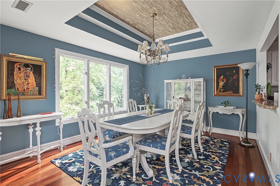 3131 Stony Point Road, #B, Richmond, VA 23235 Tray ceiling with textured inset and chandelier, expansive windows, wood-finish flooring, built-in display cabinetry, and a pass-through counter
