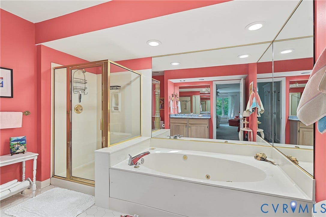 3131 Stony Point Road, #B, Richmond, VA 23235 Built-in jetted tub, enclosed shower with brass-finish frame, recessed lighting, and expansive wall-mounted mirror