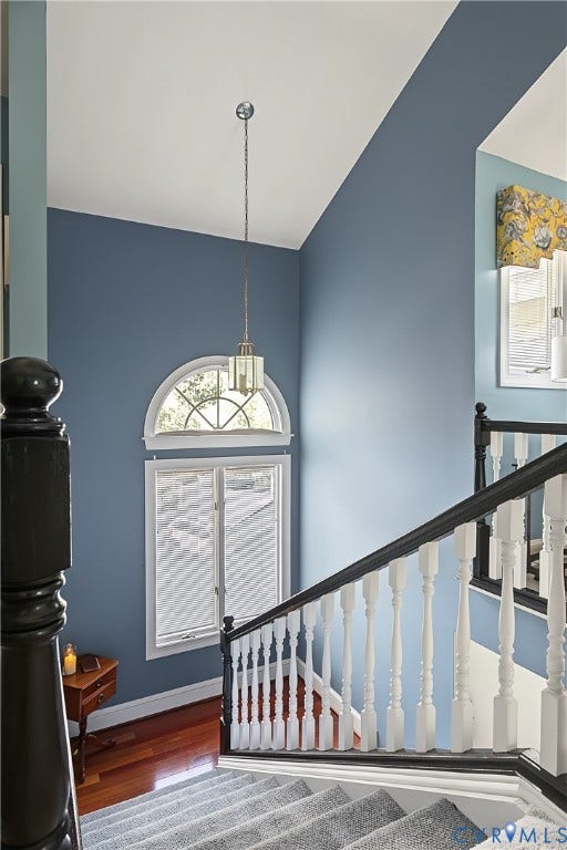 3131 Stony Point Road, #B, Richmond, VA 23235 Vaulted ceiling with pendant lighting, arched window, staircase with carpeted treads, wood flooring