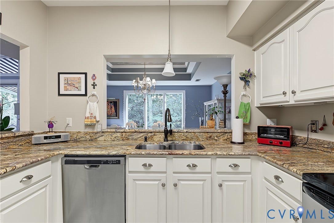3131 Stony Point Road, #B, Richmond, VA 23235 Kitchen featuring light-toned cabinetry, a double basin sink with a high-arc faucet, stainless steel dishwasher, and a pass-through window