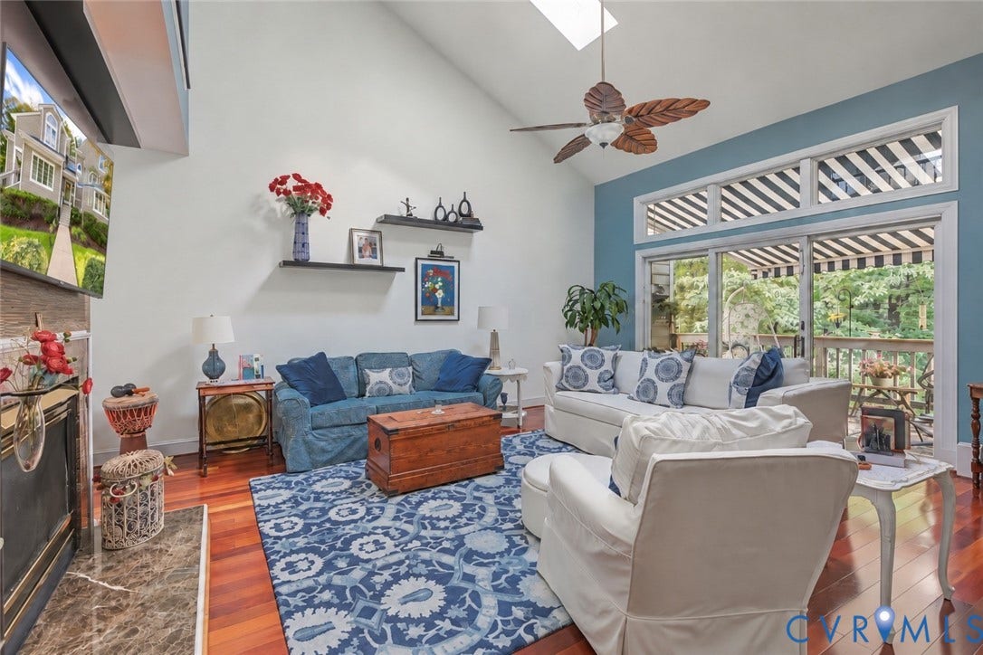 3131 Stony Point Road, #B, Richmond, VA 23235 Vaulted ceiling, skylight, hardwood flooring, sliding glass doors, and a ceiling fan with decorative blades