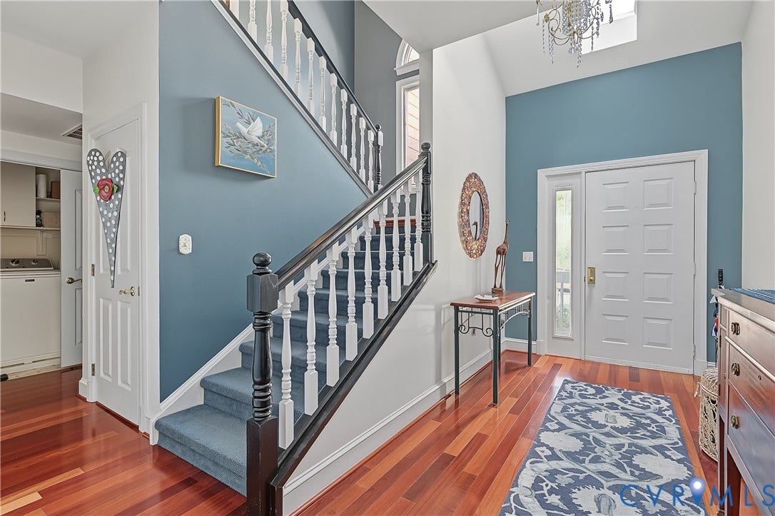 3131 Stony Point Road, #B, Richmond, VA 23235 Two-story foyer featuring wood-finish flooring, a paneled entry door with sidelight, and a chandelier