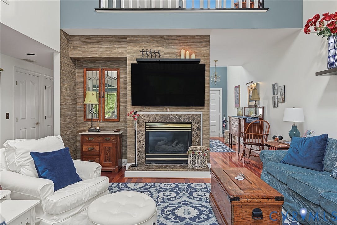 3131 Stony Point Road, #B, Richmond, VA 23235 Hardwood flooring, fireplace with stone surround, vaulted ceiling, and an upper-level railing