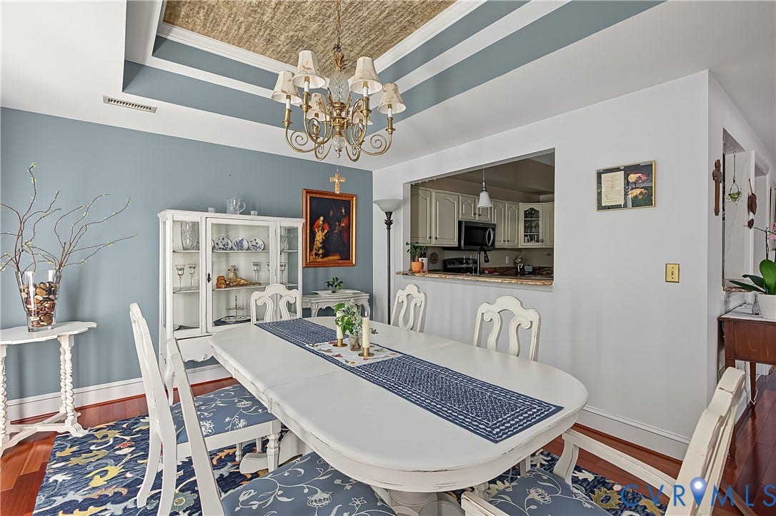 3131 Stony Point Road, #B, Richmond, VA 23235 Hardwood-finish flooring, recessed ceiling with a decorative panel, overhead chandelier, built-in display hutch, and a pass-through to the kitchen