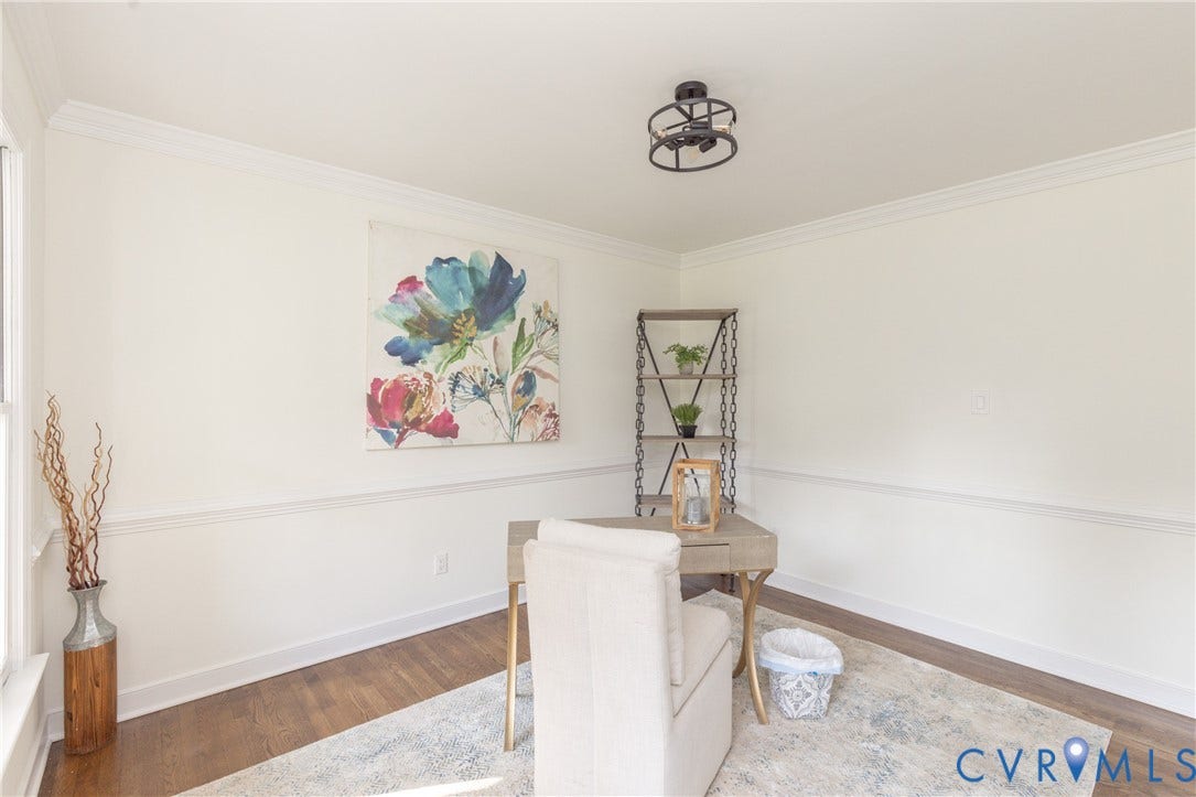 Wood-finish flooring with crisp white walls and crown molding